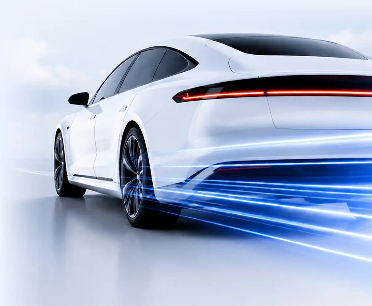 A white electric car on the move, trailing blue light streaks
